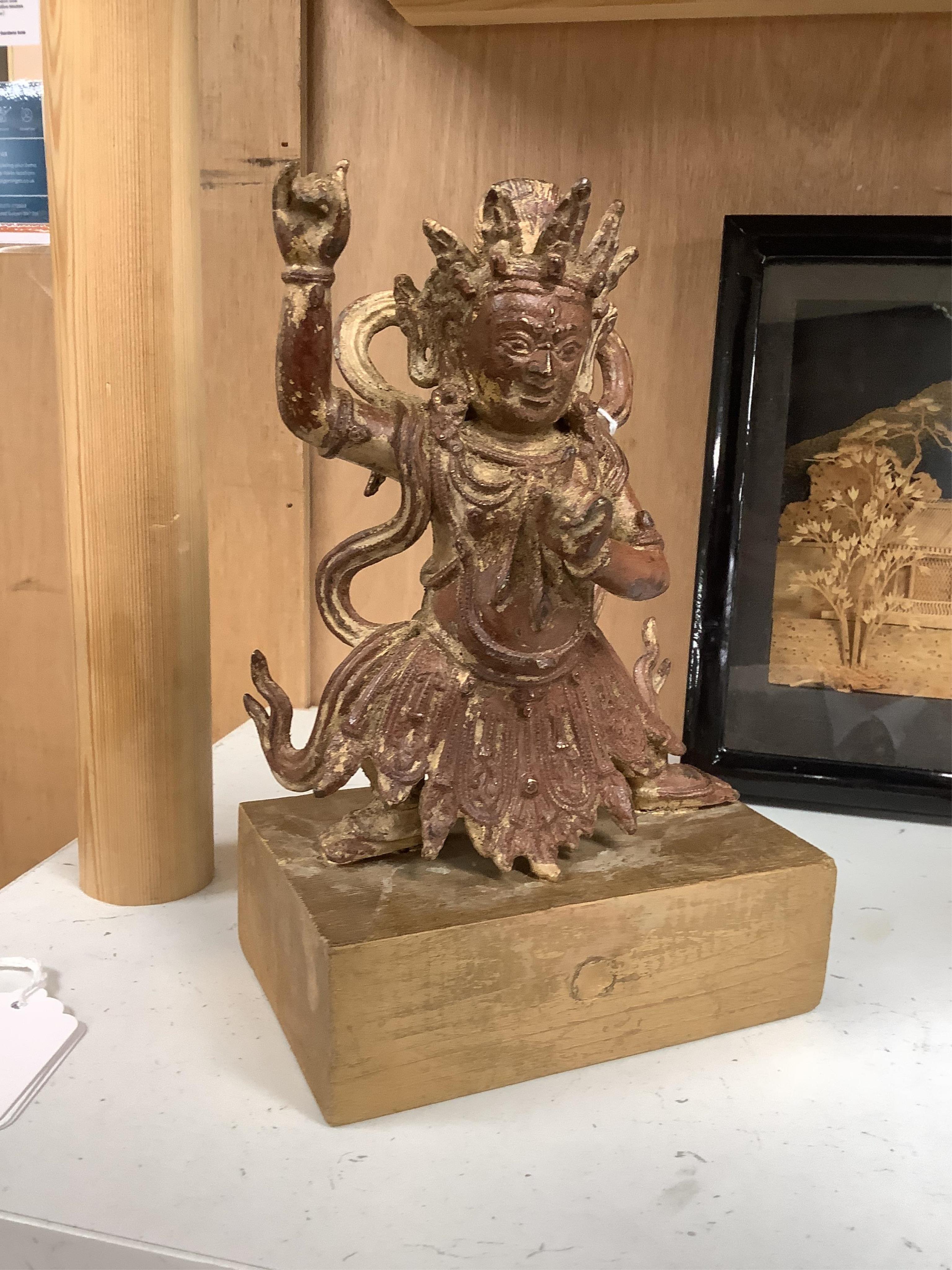 A Buddhist gilt bronze figure of Vaishravana, possibly Tibetan, 21 cm including wooden stand.